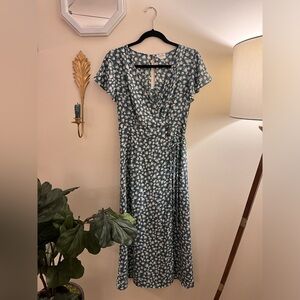 Blue floral faux wrap dress with buttons, tie, and slit